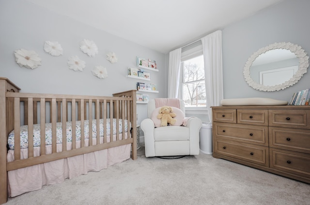 carpeted bedroom with a nursery area