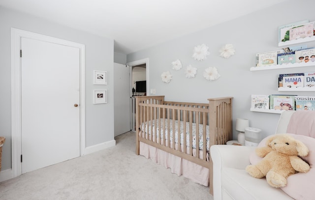 carpeted bedroom with a crib