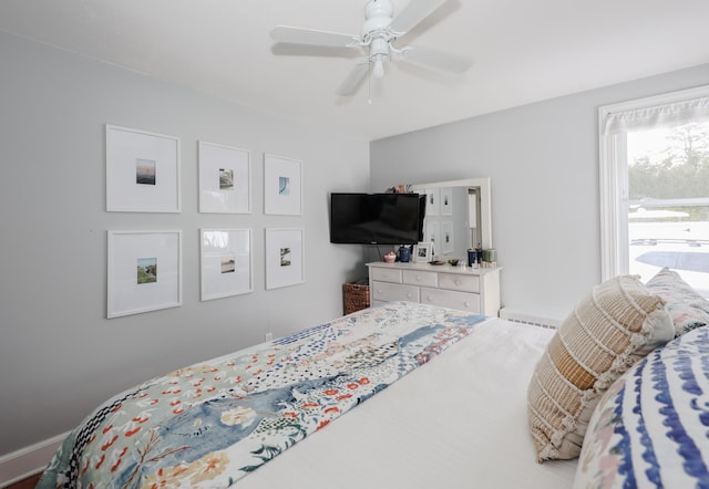 bedroom featuring a ceiling fan and a baseboard radiator