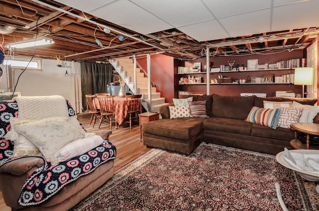 living area with wood finished floors and stairs