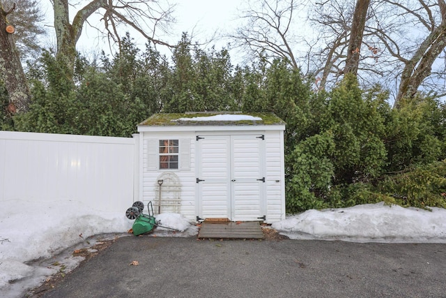 view of shed featuring fence