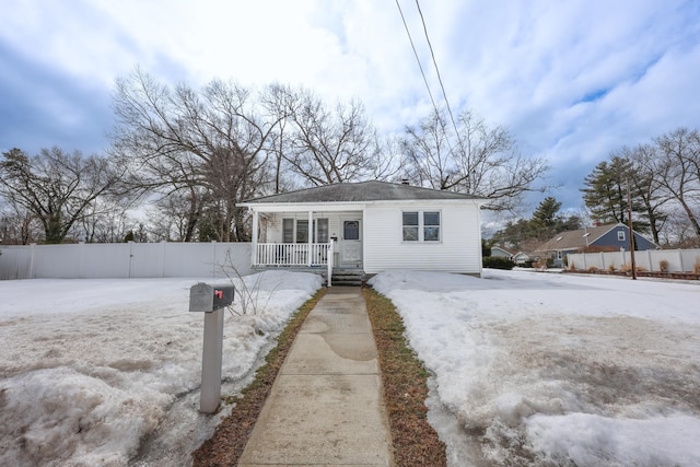 bungalow with fence and covered porch