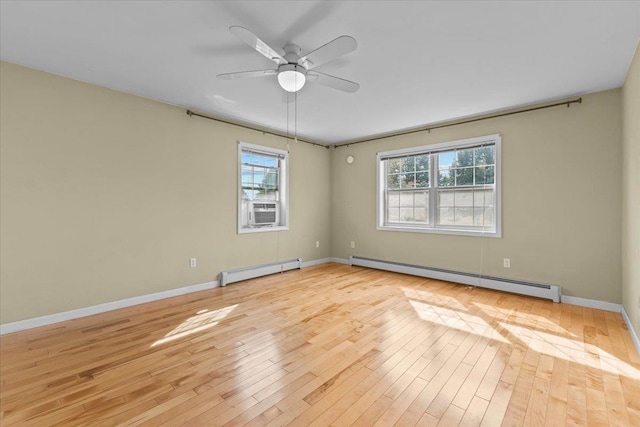 empty room featuring a ceiling fan, baseboards, a baseboard radiator, light wood-style flooring, and baseboard heating