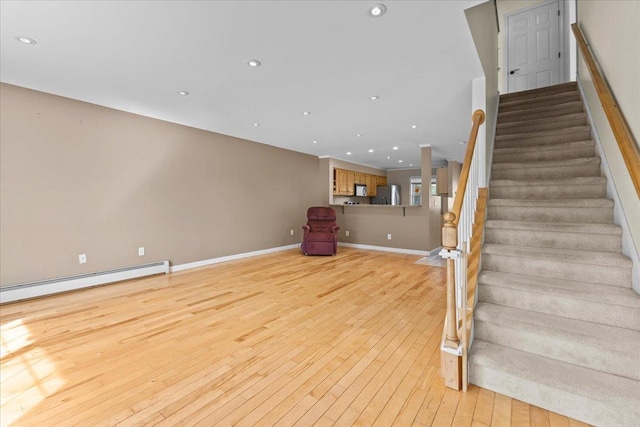 staircase with recessed lighting, baseboards, and hardwood / wood-style flooring