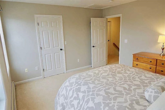 bedroom featuring light carpet and baseboards