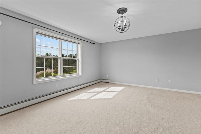 carpeted empty room with baseboards, baseboard heating, and an inviting chandelier