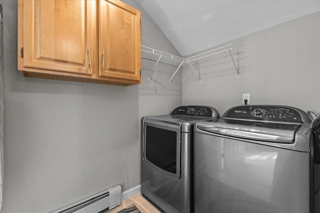 clothes washing area featuring baseboards, a baseboard radiator, cabinet space, and independent washer and dryer