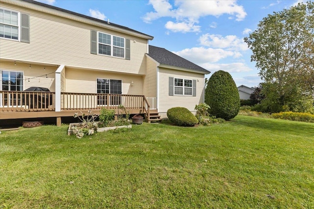 back of house with a deck and a yard