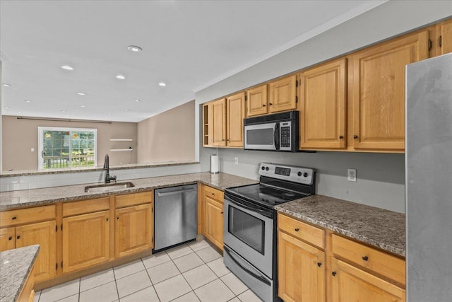 kitchen with stone counters, recessed lighting, appliances with stainless steel finishes, light tile patterned flooring, and a sink