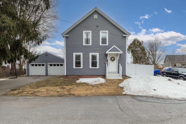 traditional-style home with fence and driveway