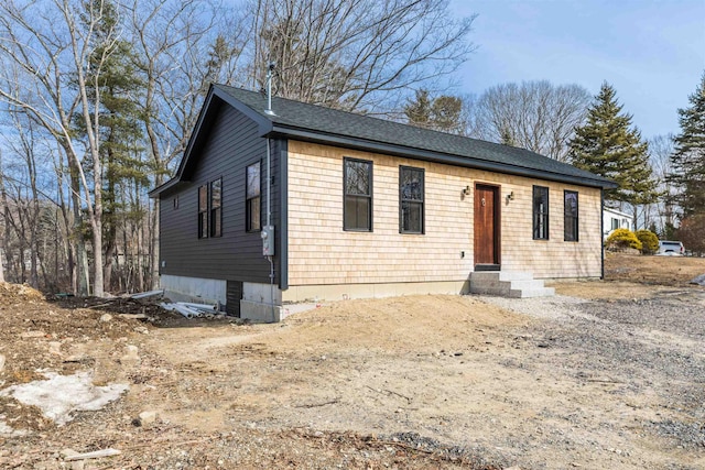 view of front of property with a shingled roof and entry steps