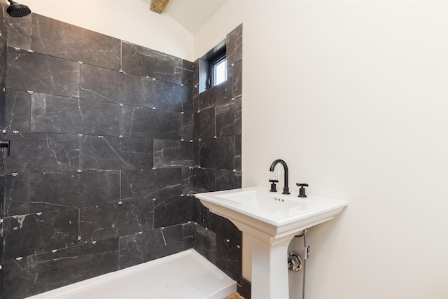 bathroom featuring a sink and tiled shower