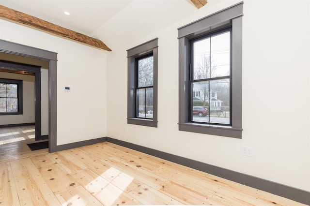 empty room featuring lofted ceiling with beams, baseboards, wood-type flooring, and recessed lighting