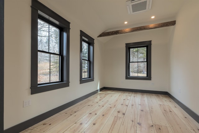 spare room with visible vents, light wood-style flooring, recessed lighting, baseboards, and vaulted ceiling