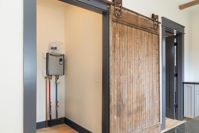 interior space featuring a barn door and baseboards