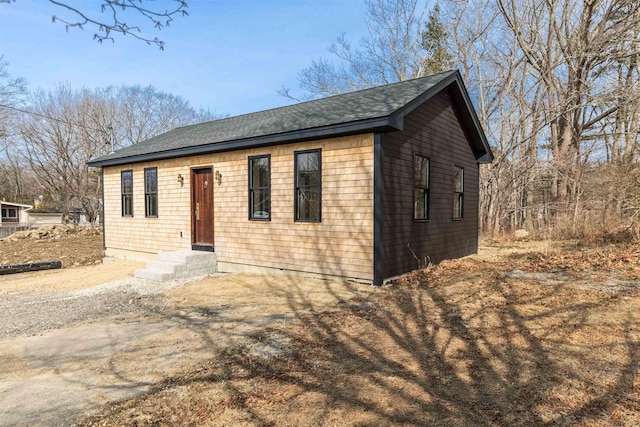 ranch-style house with roof with shingles and entry steps