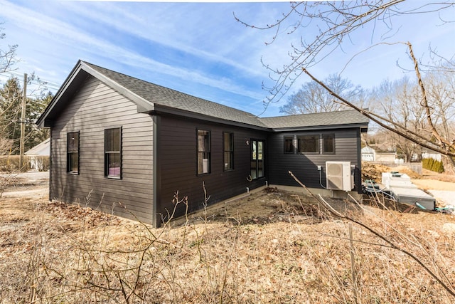 exterior space with roof with shingles