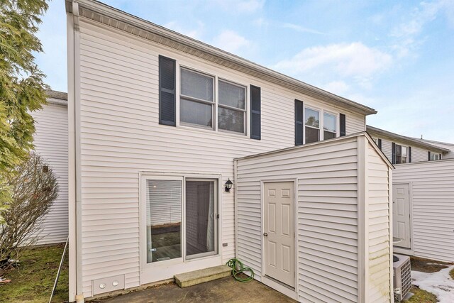 rear view of house featuring central AC unit