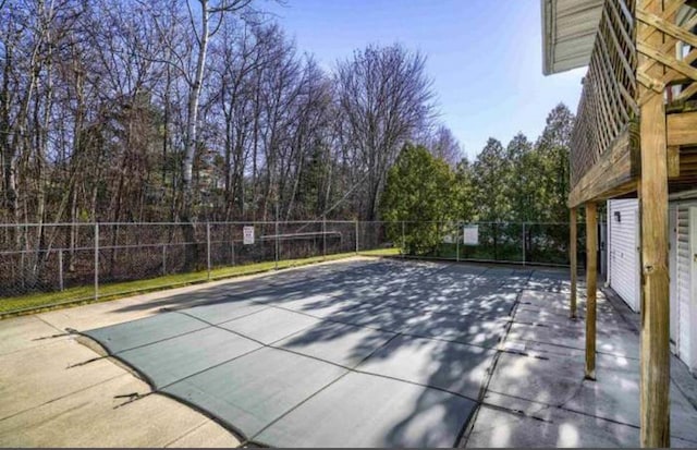 view of swimming pool with fence