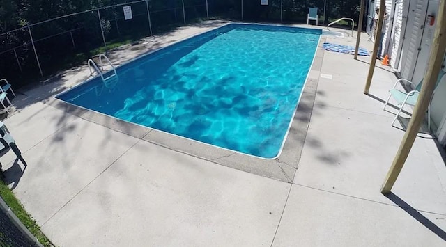 view of swimming pool featuring a fenced in pool, a patio, and fence