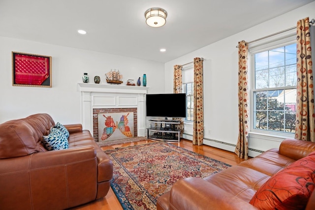 living area with a fireplace, recessed lighting, and wood finished floors