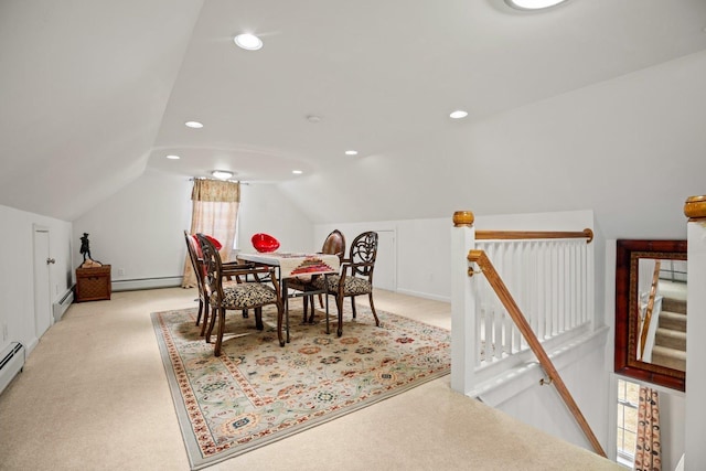 dining space featuring vaulted ceiling, light colored carpet, and baseboard heating