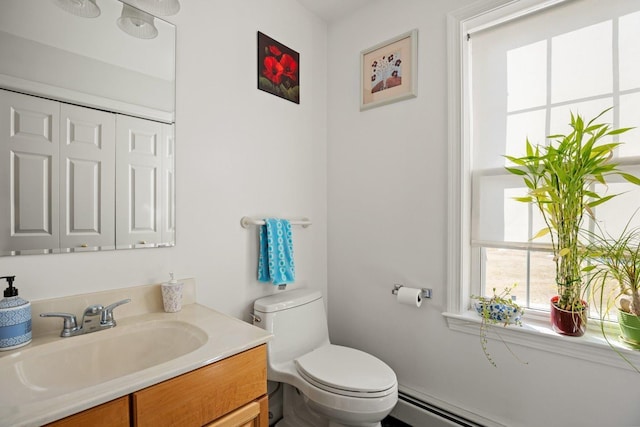 bathroom featuring a baseboard heating unit, toilet, and vanity