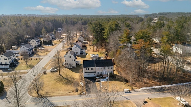 aerial view featuring a forest view and a residential view