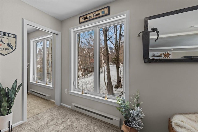 interior space featuring baseboards, baseboard heating, and carpet flooring