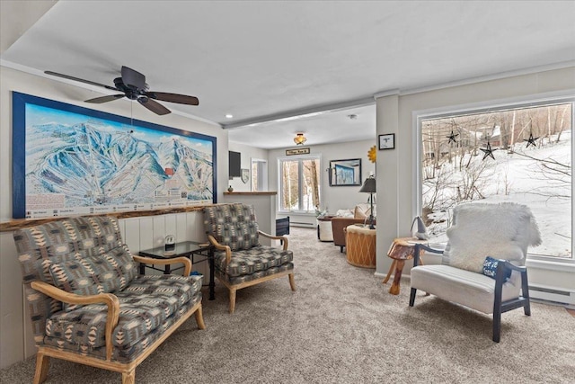 living area featuring baseboard heating, ceiling fan, and carpet flooring