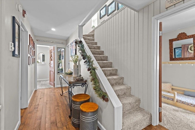 stairway with recessed lighting, baseboards, and wood-type flooring