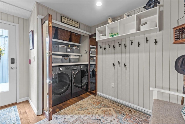 laundry room with wood finished floors, laundry area, and washing machine and clothes dryer