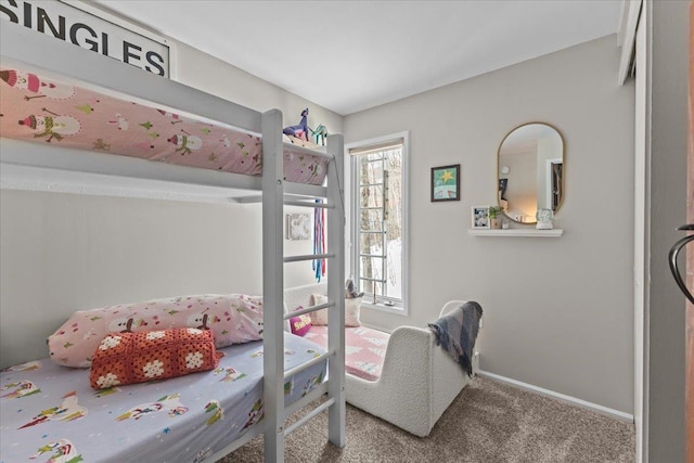 bedroom featuring baseboards and carpet