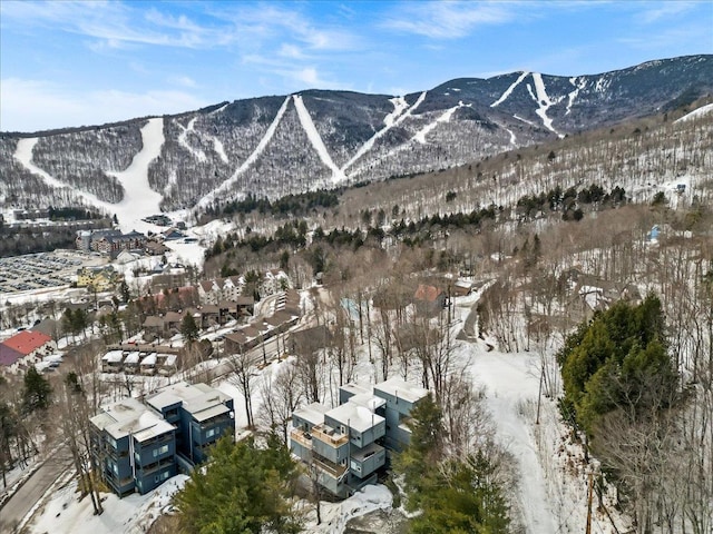 snowy aerial view with a mountain view