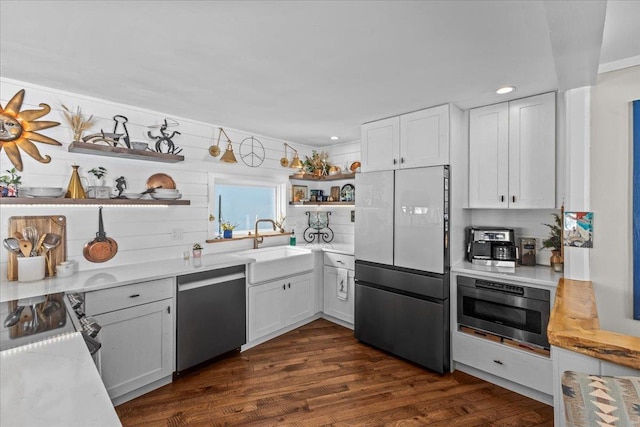 kitchen with open shelves, dishwasher, freestanding refrigerator, dark wood-style floors, and a sink