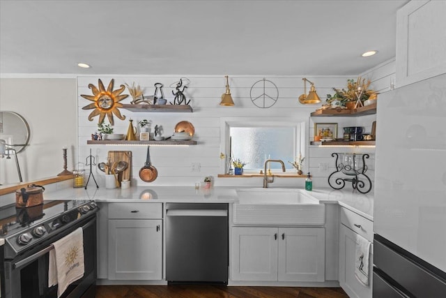 kitchen with black electric range, open shelves, stainless steel dishwasher, and a sink