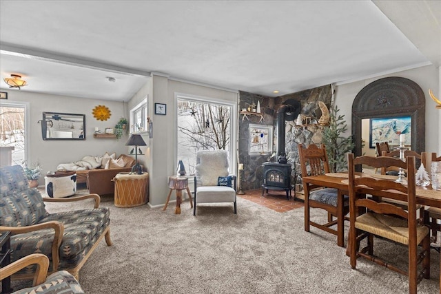 carpeted dining space featuring a wood stove