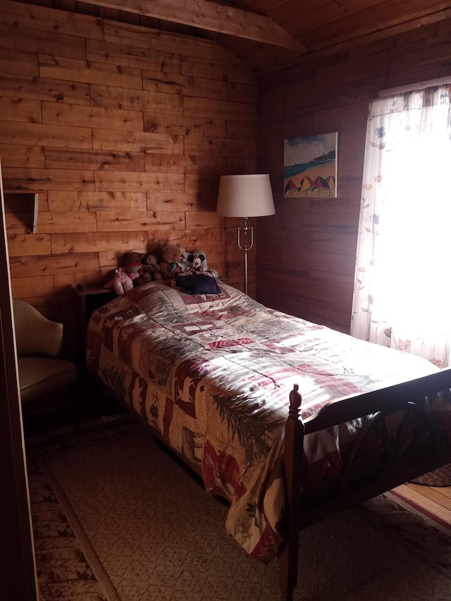 bedroom with lofted ceiling and wooden walls