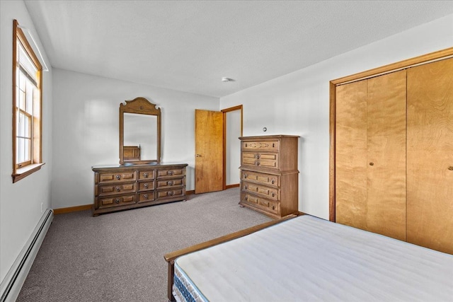 unfurnished bedroom featuring baseboards, carpet, a closet, a textured ceiling, and a baseboard radiator