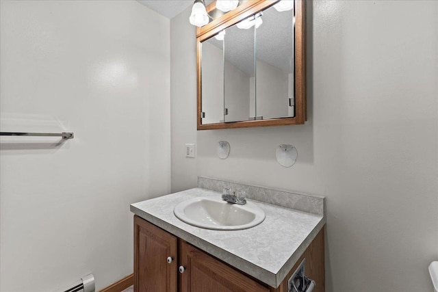 bathroom with a baseboard radiator and vanity