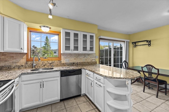 kitchen featuring a sink, open shelves, appliances with stainless steel finishes, a peninsula, and white cabinets