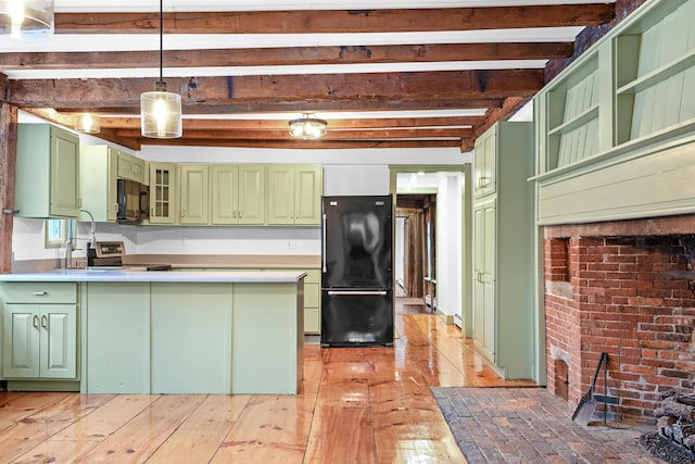 kitchen featuring green cabinets, beam ceiling, a peninsula, hanging light fixtures, and black appliances