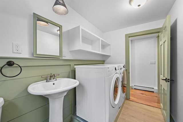 washroom featuring baseboard heating, independent washer and dryer, laundry area, and light wood-style floors