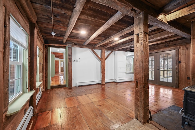 interior space with beam ceiling, baseboard heating, hardwood / wood-style floors, and wooden ceiling