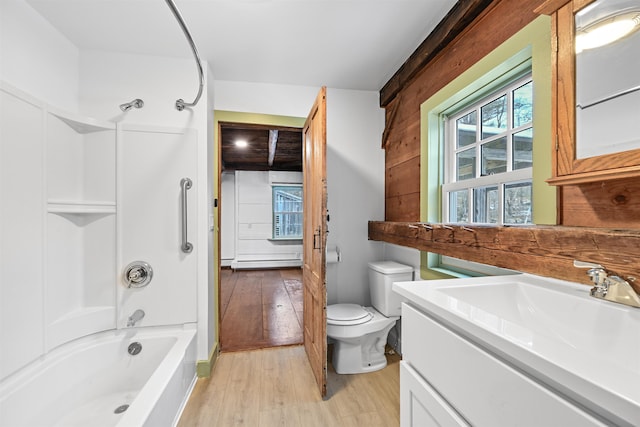 full bath with toilet, shower / washtub combination, wood finished floors, baseboard heating, and vanity