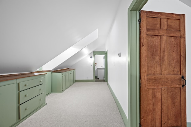 bonus room with light colored carpet, baseboards, and lofted ceiling