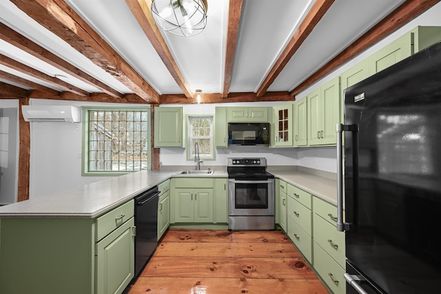 kitchen with a wall mounted air conditioner, black appliances, a sink, a peninsula, and green cabinets