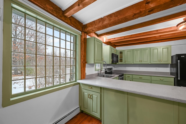 kitchen with beam ceiling, black appliances, plenty of natural light, green cabinets, and baseboard heating