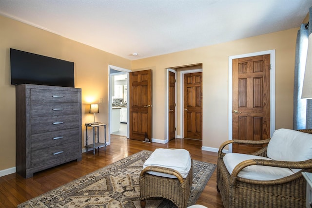 living area featuring dark wood-type flooring and baseboards