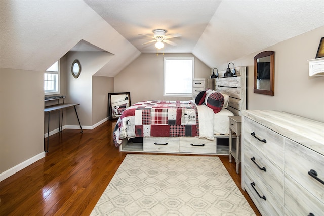 bedroom with dark wood finished floors, multiple windows, and vaulted ceiling